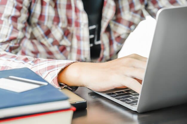 A close-up of a student carefully filling out an online form on a laptop, highlighting the process of applying for the Ministry of Education scholarships with good light.