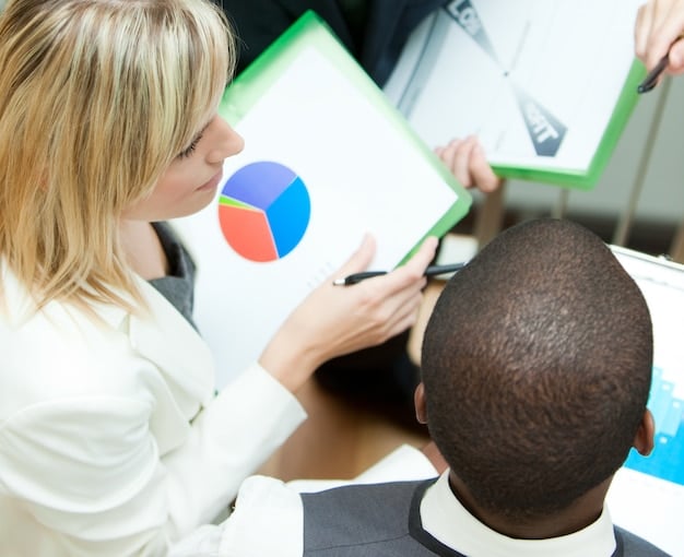 A detailed closeup of a diverse group of people analyzing financial charts and data on multiple screens in a modern office, symbolizing the collaborative effort to understand and adapt to new banking regulations.