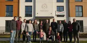Families and individuals benefiting from 2026 state housing assistance programs, standing in front of affordable housing.